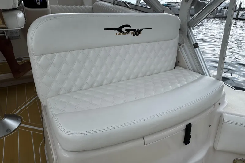 Slide: The Image of Luxurious seating on 2001 Grady-White Express 330 boat, featuring quilted white upholstery. - 33