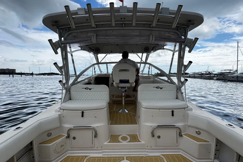 Slide: The Image of 2001 Grady-White Express 330 boat interior with seating, on calm water, under cloudy sky. - 34