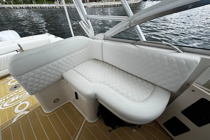 Slide: The Image of Luxurious seating on 2001 Grady-White Express 330 boat, featuring quilted white upholstery. - 35