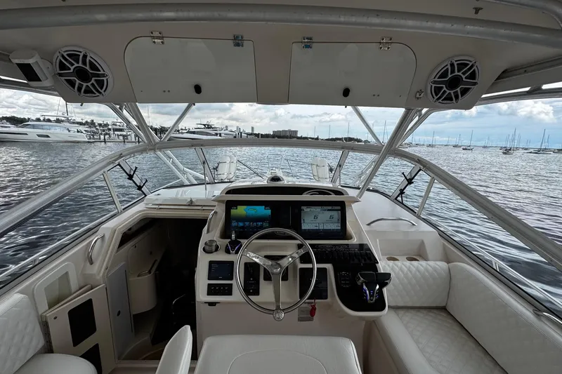 Slide: The Image of 2001 Grady-White Express 330 boat interior with steering wheel and navigation system. - 37