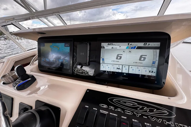 Slide: The Image of Dashboard of a 2001 Grady-White Express 330 boat with modern navigation displays. - 39