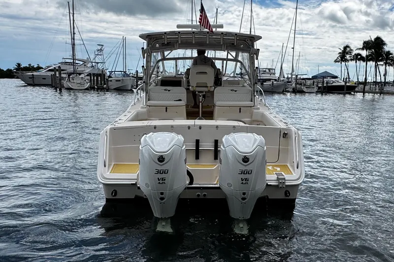 Slide: The Image of 2001 Grady-White Express 330 boat with twin 300 V6 engines docked in marina. - 4