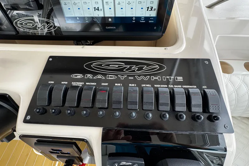 Slide: The Image of Control panel of a 2001 Grady-White Express 330 boat with switches and Garmin display. - 40