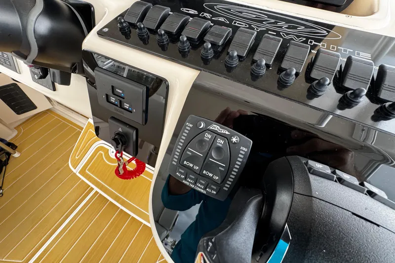 Slide: The Image of Control panel of a 2001 Grady-White Express 330 boat with switches and throttle. - 42