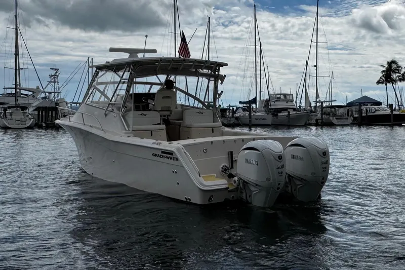 Slide: The Image of 2001 Grady-White Express 330 boat docked in marina with twin Yamaha engines. - 5