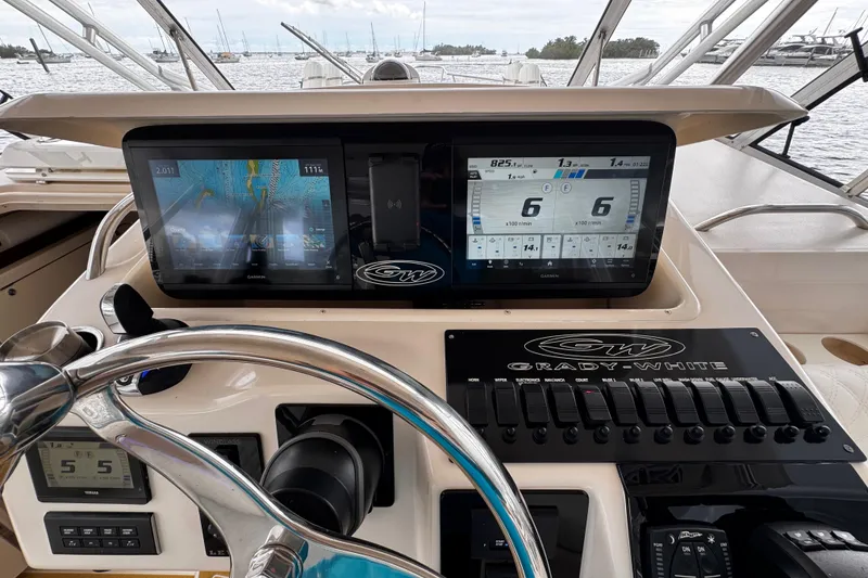 Slide: The Image of Control panel of a 2001 Grady-White Express 330 boat with navigation screens. - 51