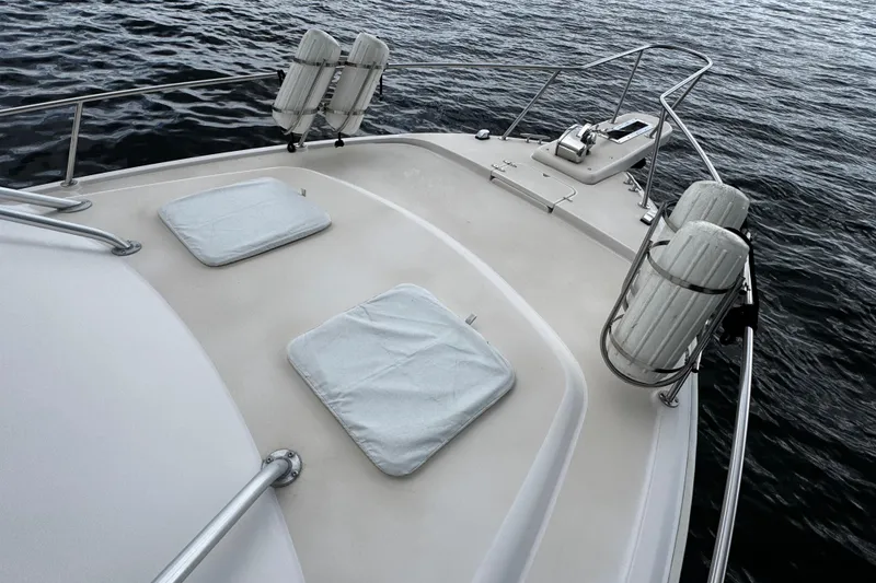 Slide: The Image of 2001 Grady-White Express 330 boat deck with cushions and railing on the water. - 53