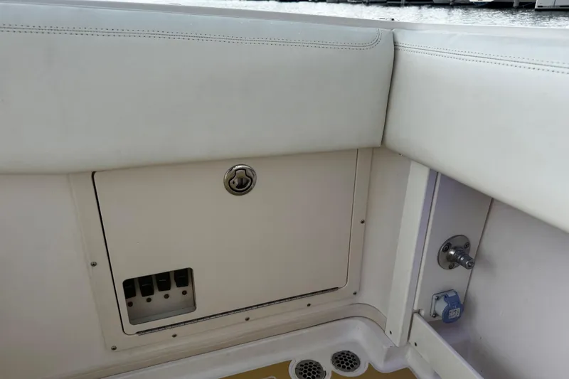 Slide: The Image of 2001 Grady-White Express 330 boat interior, featuring storage compartment and seating area. - 62