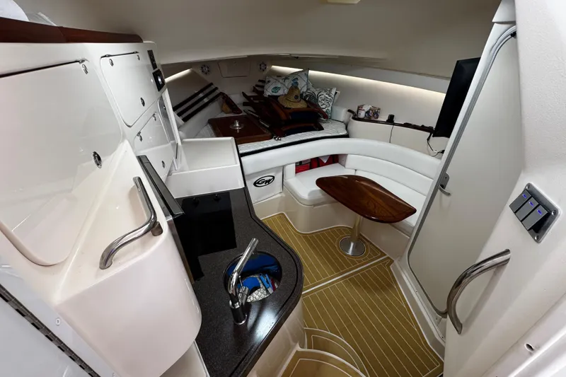 Slide: The Image of 2001 Grady-White Express 330 cabin interior with kitchenette, seating, and wooden table. - 63