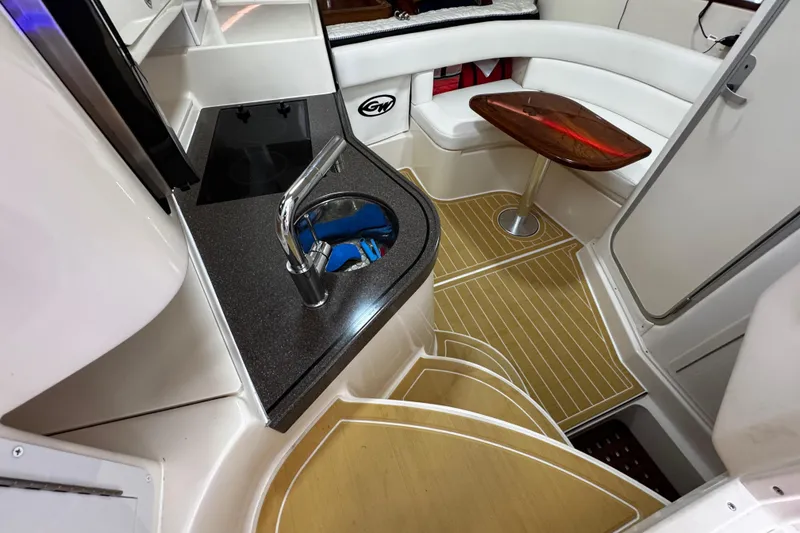 Slide: The Image of 2001 Grady-White Express 330 interior with kitchenette, seating, and wooden flooring. - 64