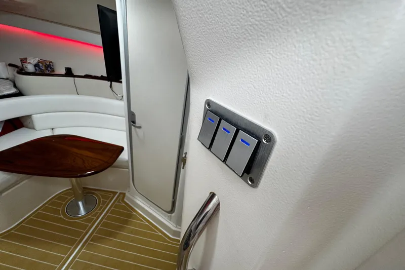 Slide: The Image of Interior of 2001 Grady-White Express 330 boat with modern switches and seating area. - 65