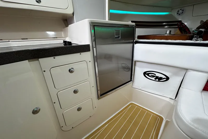 Slide: The Image of 2001 Grady-White Express 330 interior with storage drawers and stainless steel fridge. - 68