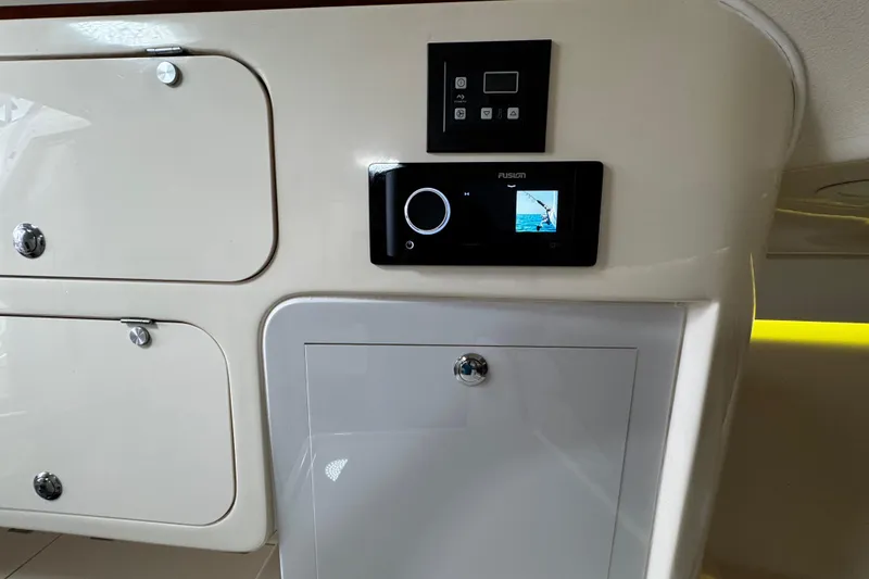 Slide: The Image of Control panel and storage on 2001 Grady-White Express 330 boat interior. - 70