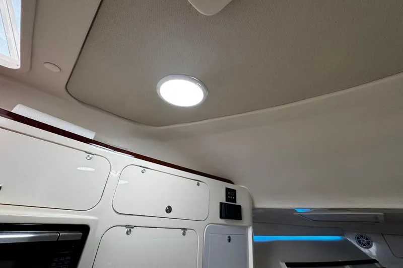 Slide: The Image of 2001 Grady-White Express 330 cabin interior with modern lighting and storage cabinets. - 79