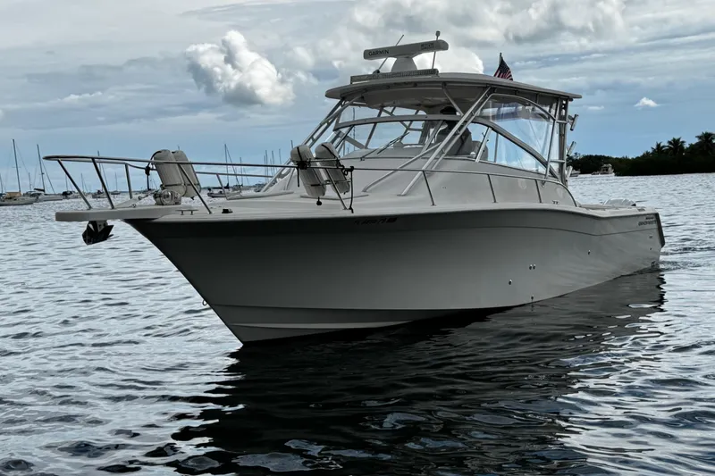 Slide: The Image of 2001 Grady-White Express 330 boat on calm water, cloudy sky background. - 8