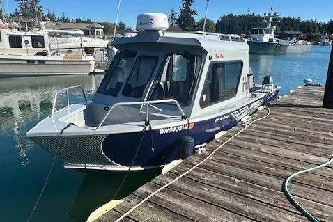 Slide: The Image of 2023 Hewescraft 210 Sea Runner ET HT boat on trailer, parked outdoors. - 0