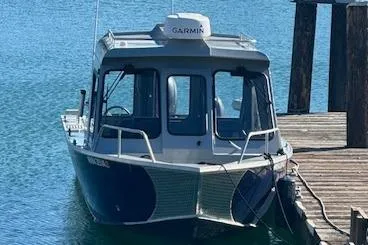 Slide: The Image of 2023 Hewescraft 210 Sea Runner ET HT boat docked in a marina. - 1