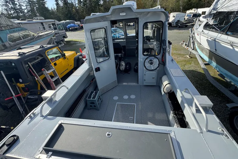 Slide: The Image of 2023 Hewescraft 210 Sea Runner ET HT boat interior, showcasing spacious deck and steering area. - 12