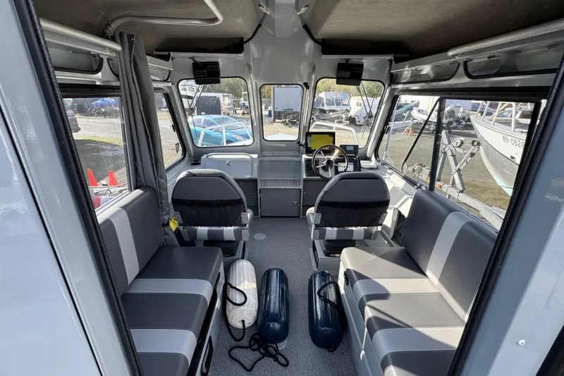 Slide: The Image of Interior of 2023 Hewescraft 210 Sea Runner ET HT boat, featuring seating and steering console. - 13