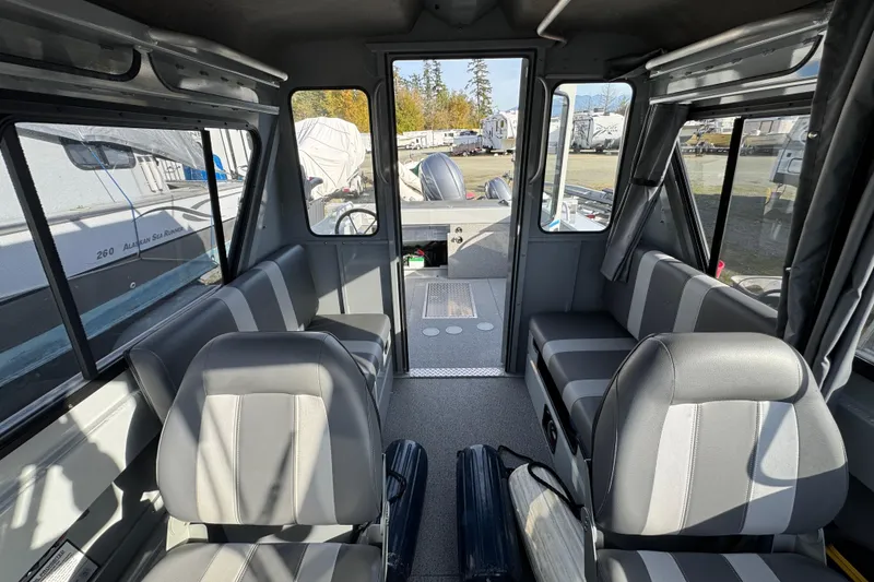 Slide: The Image of Interior of 2023 Hewescraft 210 Sea Runner ET HT boat, featuring seating and windows. - 17