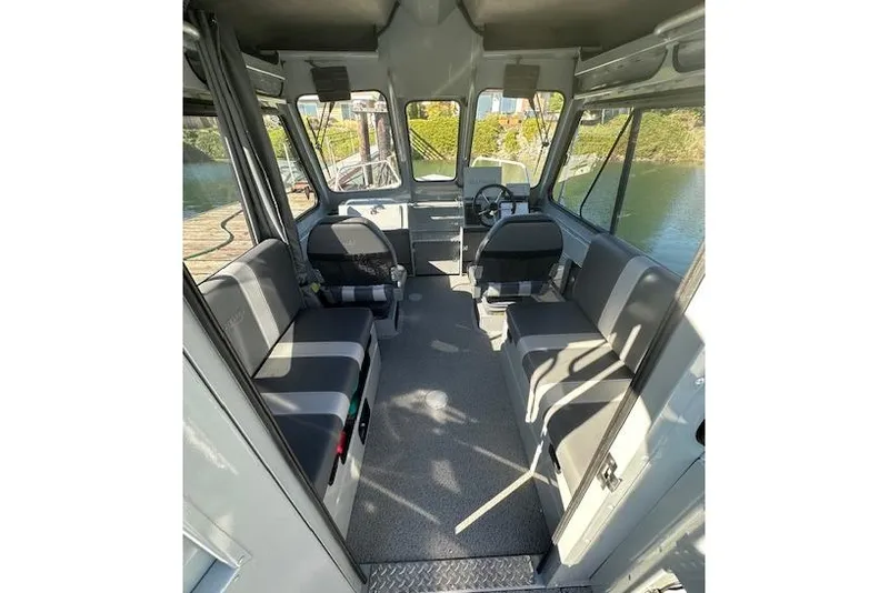 Slide: The Image of 2023 Hewescraft 210 Sea Runner ET HT boat docked with Yamaha outboard motor. - 4