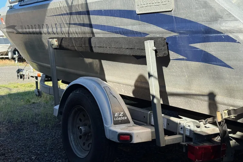 Slide: The Image of Trailer with 2000 Harbor Craft Nahanni 1925 SK boat, featuring EZ Loader branding. - 10