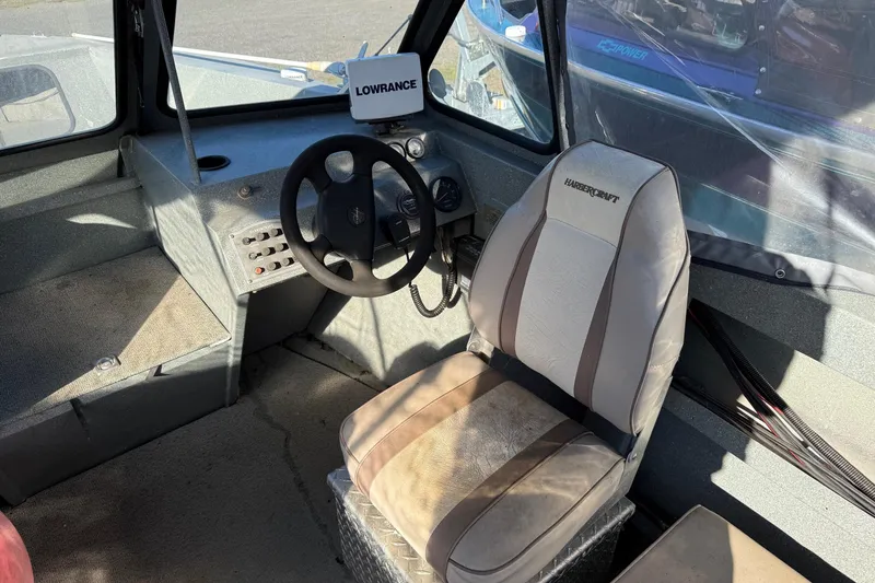 Slide: The Image of Interior of a 2000 Harbor Craft Nahanni 1925 SK boat with steering wheel and seat. - 16