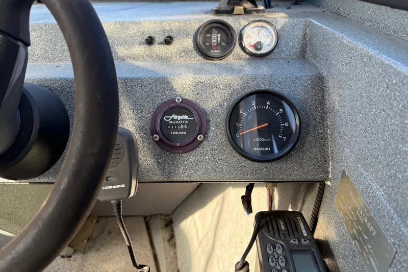 Slide: The Image of Dashboard of a 2000 Harbor Craft Nahanni 1925 SK boat with gauges and controls. - 18