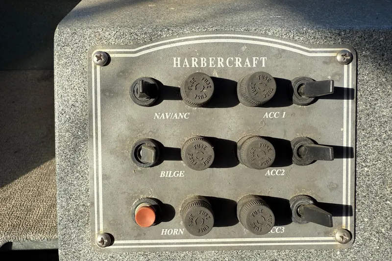 Slide: The Image of Control panel of a 2000 Harbor Craft Nahanni 1925 SK boat with labeled switches. - 21