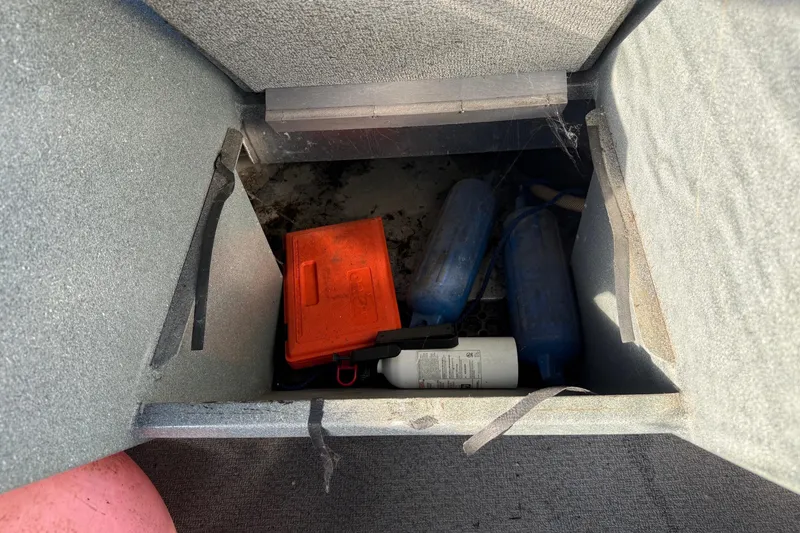 Slide: The Image of Storage compartment in a 2000 Harbor Craft Nahanni 1925 SK boat with safety equipment. - 22