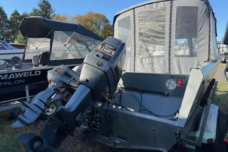 Slide: The Image of 2000 Harbor Craft Nahanni 1925 SK boat with Suzuki outboard motor, parked outdoors. - 3