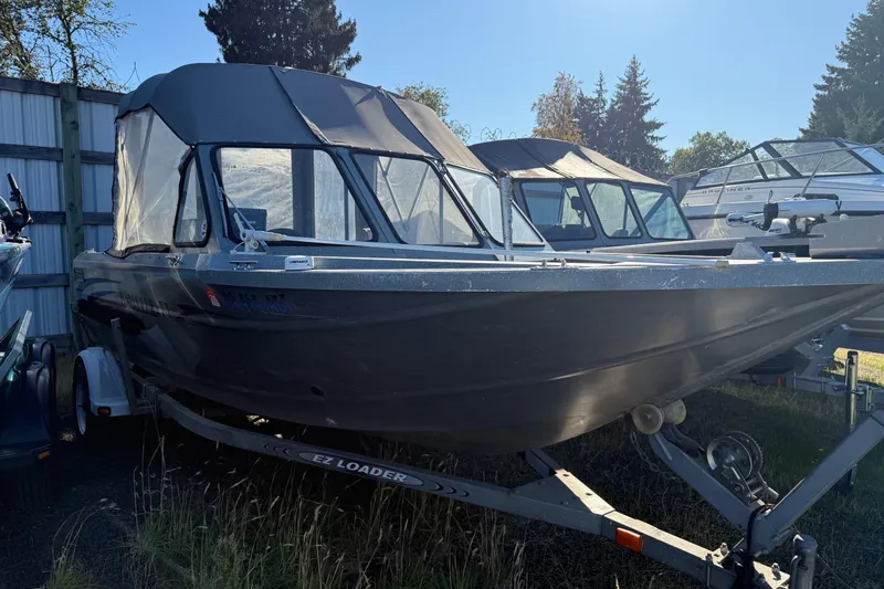 Slide: The Image of 2000 Harbor Craft Nahanni 1925 SK boat on trailer, parked outdoors. - 4