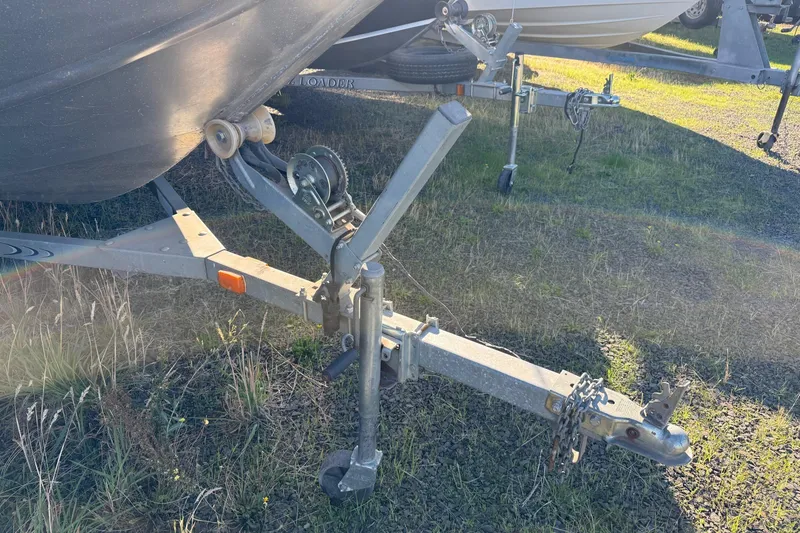 Slide: The Image of Trailer hitch of a 2000 Harbor Craft Nahanni 1925 SK boat on grass. - 5