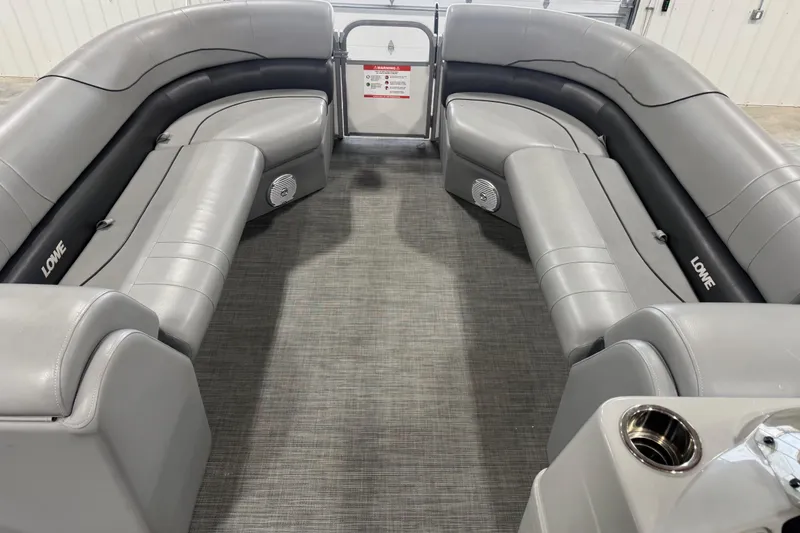 Slide: The Image of Interior of a 2021 Lowe SS 270 pontoon boat with gray seating and carpet. - 10