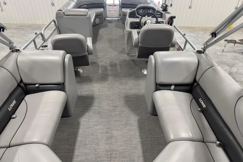 Slide: The Image of Interior of 2021 Lowe SS 270 pontoon boat with gray seating and steering console. - 12