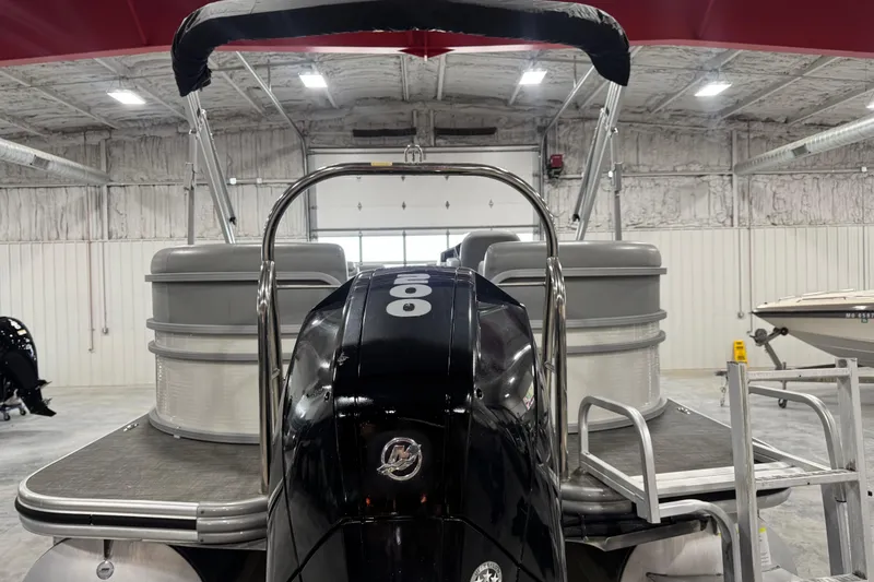 Slide: The Image of 2021 Lowe SS 270 pontoon boat in a warehouse, rear view with motor. - 5