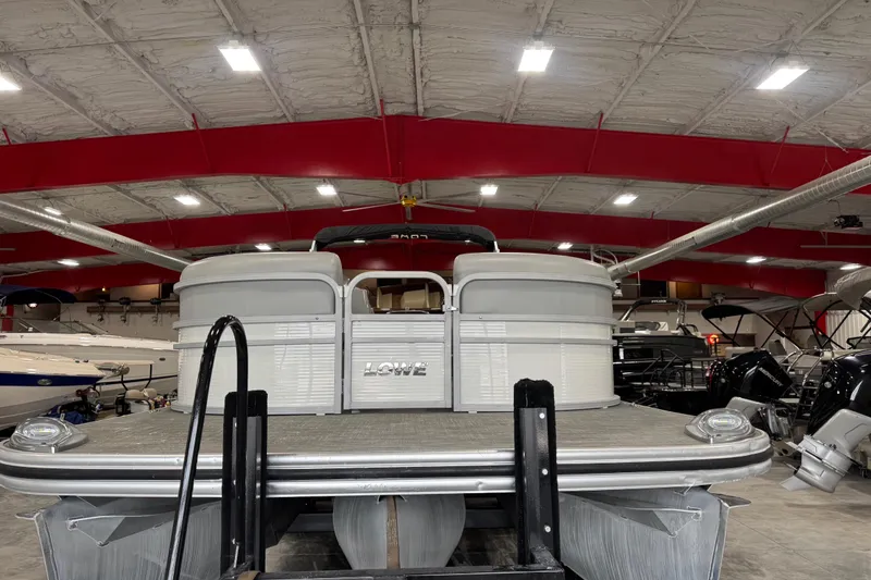Slide: The Image of 2021 Lowe SS 270 pontoon boat in showroom with red ceiling and bright lighting. - 6