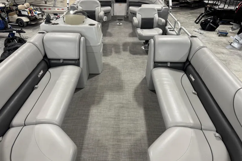 Slide: The Image of 2021 Lowe SS 270 pontoon boat interior with gray seating and steering console. - 8