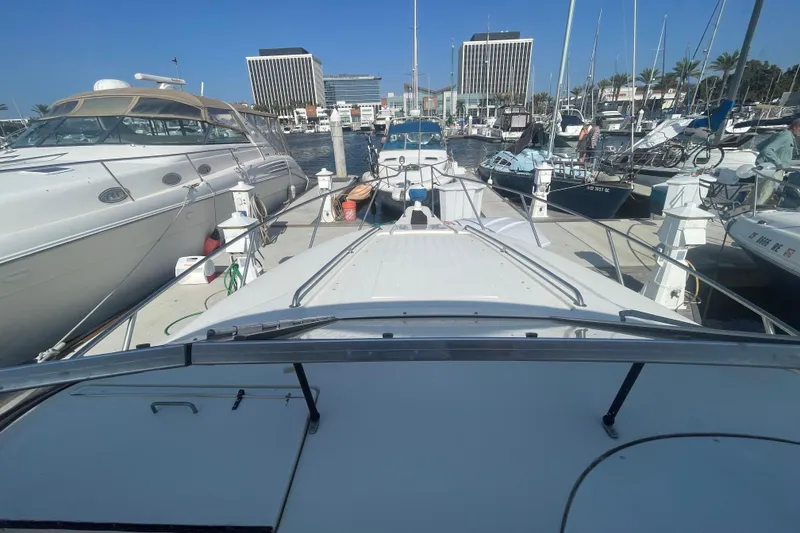 Slide: The Image of 2001 Monterey 270 Cruiser docked at a marina, surrounded by other boats. - 10
