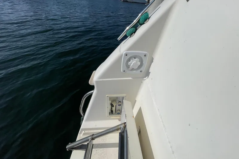 Slide: The Image of 2001 Monterey 270 Cruiser boat deck with railing, docked on calm water. - 11