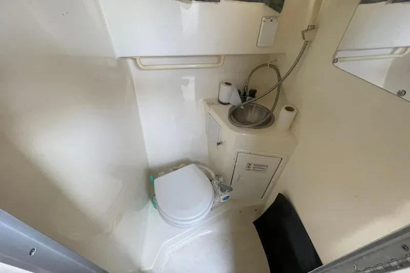 Slide: The Image of Compact bathroom in 2001 Monterey 270 Cruiser with toilet, sink, and storage. - 17