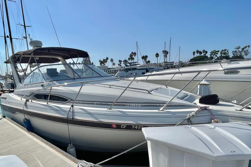 Slide: The Image of 2001 Monterey 270 Cruiser docked at marina under clear blue sky. - 2