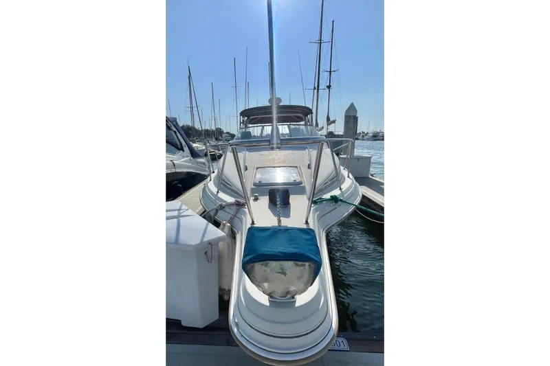 Slide: The Image of 2001 Monterey 270 Cruiser docked at marina, front view with clear sky. - 3