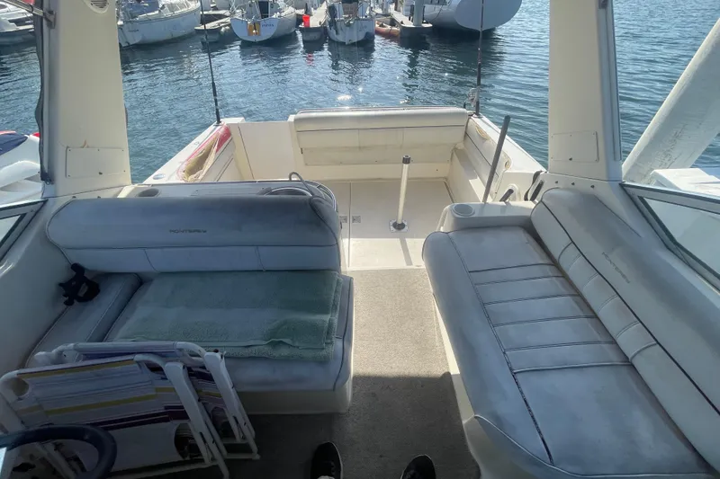 Slide: The Image of 2001 Monterey 270 Cruiser interior with seating, docked at marina. - 5