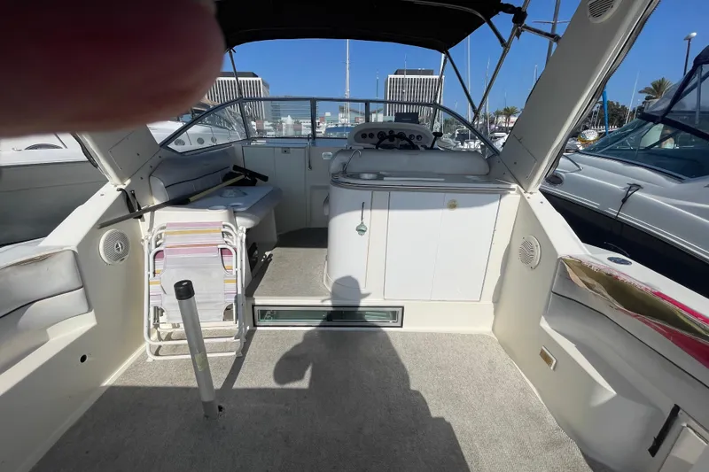 Slide: The Image of 2001 Monterey 270 Cruiser boat interior with seating and control panel in marina. - 9