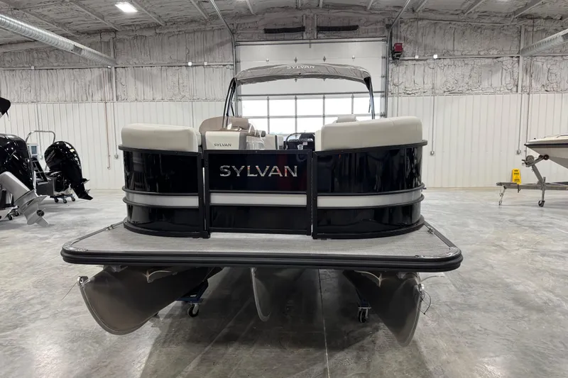 Slide: The Image of 2025 Sylvan X-5 pontoon boat in a showroom, rear view. - 6