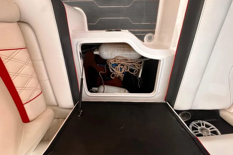 Slide: The Image of 2020 Regal LS2 Surf boat storage compartment with ropes and fender. - 11