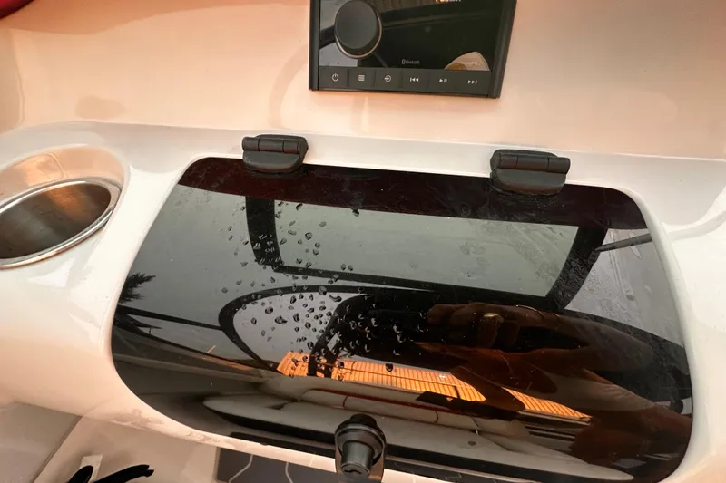 Slide: The Image of 2020 Regal LS2 Surf boat dashboard with control panel and cup holder. - 12