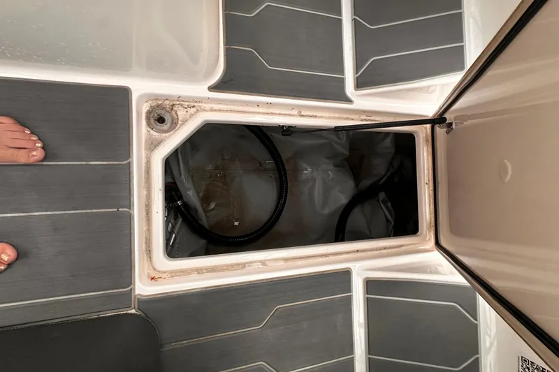 Slide: The Image of Open storage compartment on 2020 Regal LS2 Surf boat deck. - 14