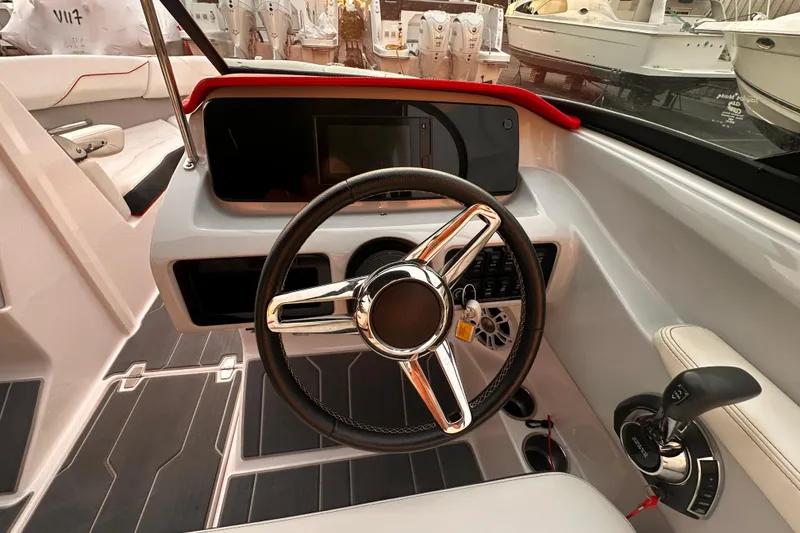 Slide: The Image of 2020 Regal LS2 Surf boat cockpit with modern steering wheel and controls. - 16